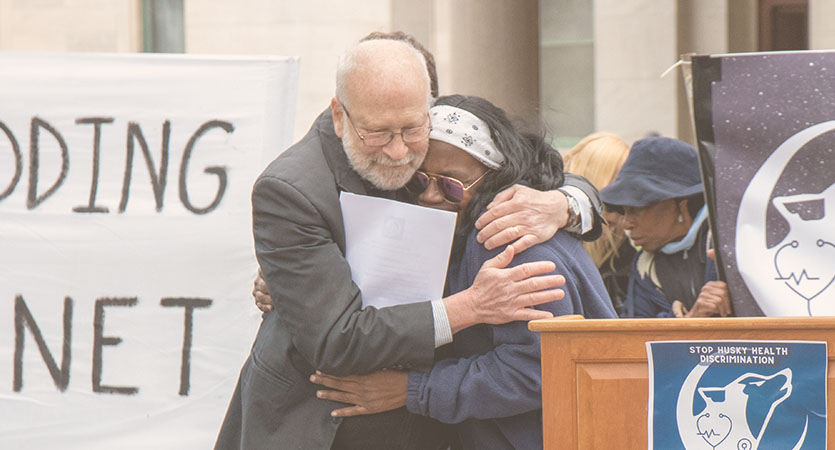 Two KTP members hugging at a rally.
